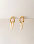gold textured hoop earrings with hanging white pearl strands, elegant statement pierced jewelry