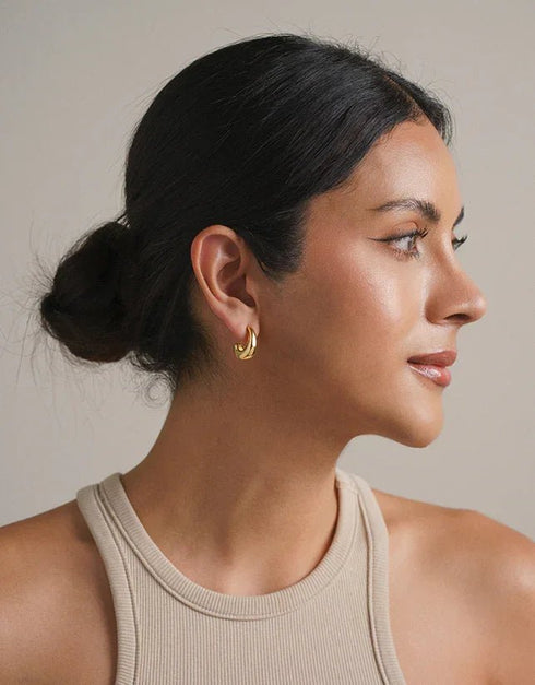 gold hoop earrings with polished finish featuring a sleek twisted design, modern minimalist style