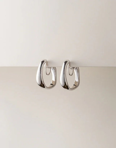 silver polished hoop earrings with organic, curved design, modern minimalist style
