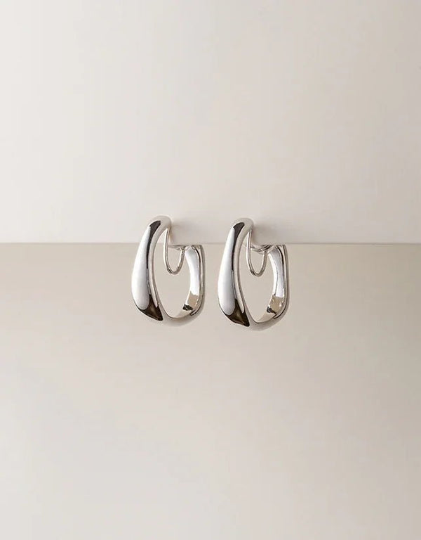 silver polished hoop earrings with organic, curved design, modern minimalist style