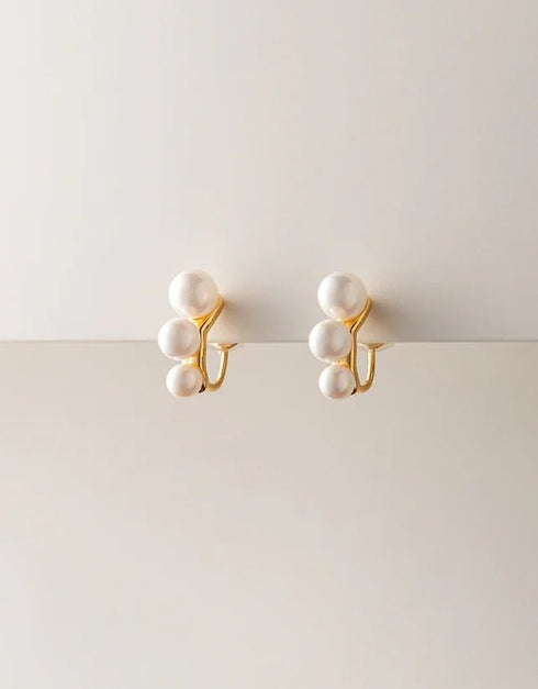 Gold finish pierced drop earrings with three white pearls in a vertical cluster, elegant style