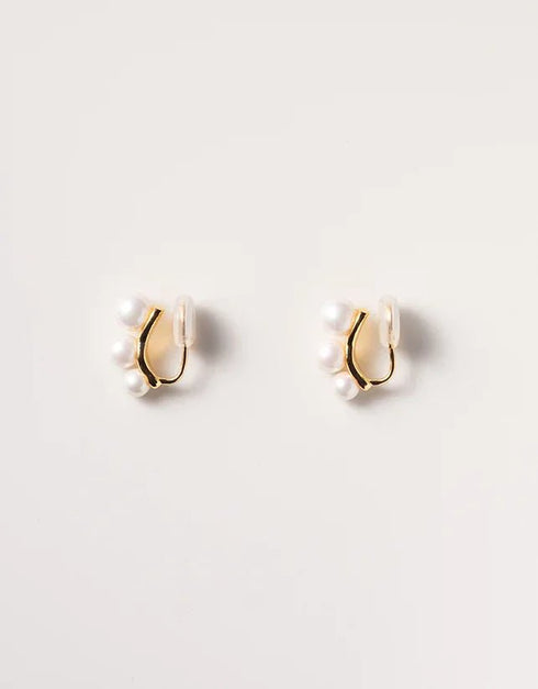Gold-tone pierced stud earrings with trio of white pearls in minimalist modern style