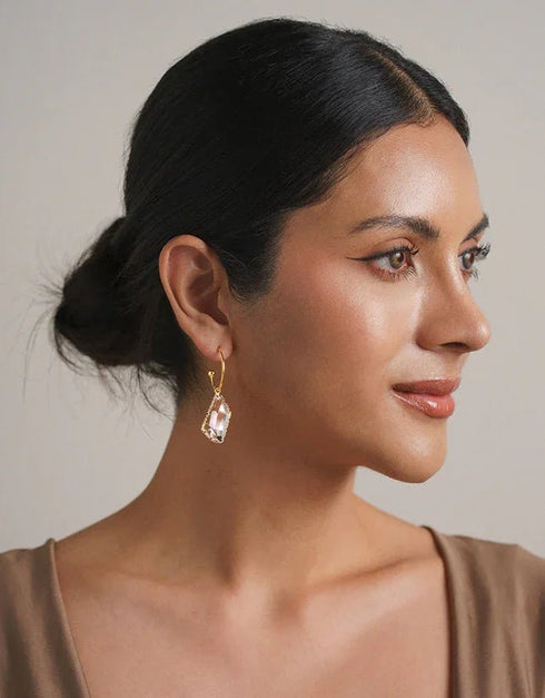 Gold hoop drop earrings with large clear geometric gemstones, elegant and modern style
