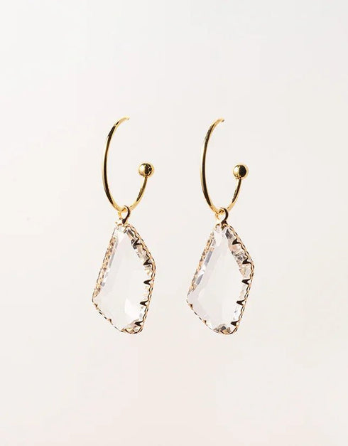 Gold hoop earrings with irregular clear crystal drop pendants, modern minimalist style pierced jewelry