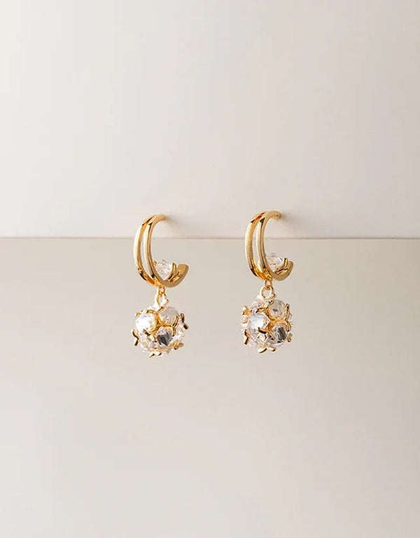 Gold pierced double hoop earrings with crystal cluster drop charm, elegant modern style