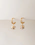 Gold pierced double hoop earrings with crystal cluster drop charm, elegant modern style