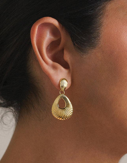 Gold pierced drop earrings with ribbed teardrop and shell-shaped studs, polished finish, elegant style