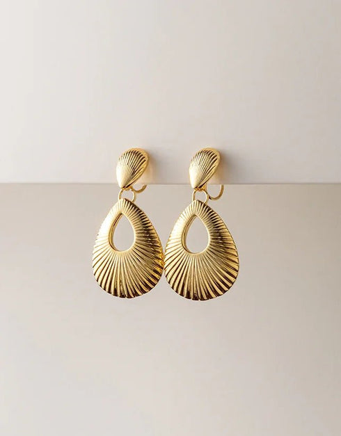 Gold-tone pierced drop earrings with textured, open teardrop shape and polished finish, elegant statement style