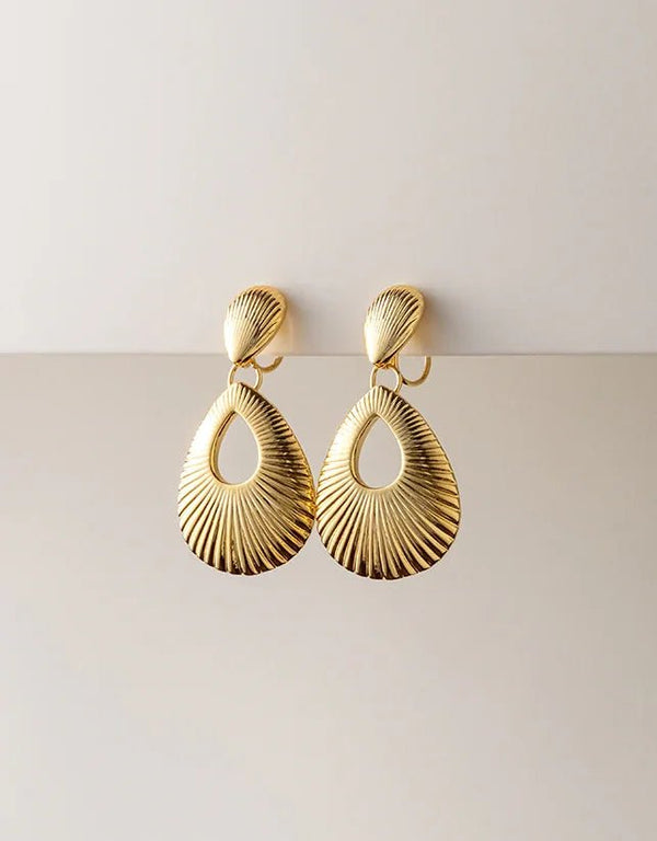 Gold-tone pierced drop earrings with textured, open teardrop shape and polished finish, elegant statement style
