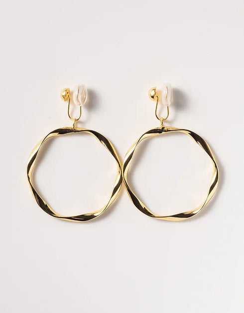 Gold-tone twisted hoop earrings with polished finish and unique irregular round shape, stylish clip-on design