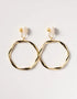 Gold-tone twisted hoop earrings with polished finish and unique irregular round shape, stylish clip-on design